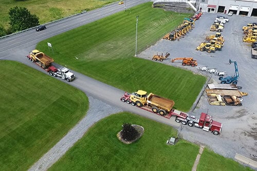 Truck Hauling Excavtor Equipment