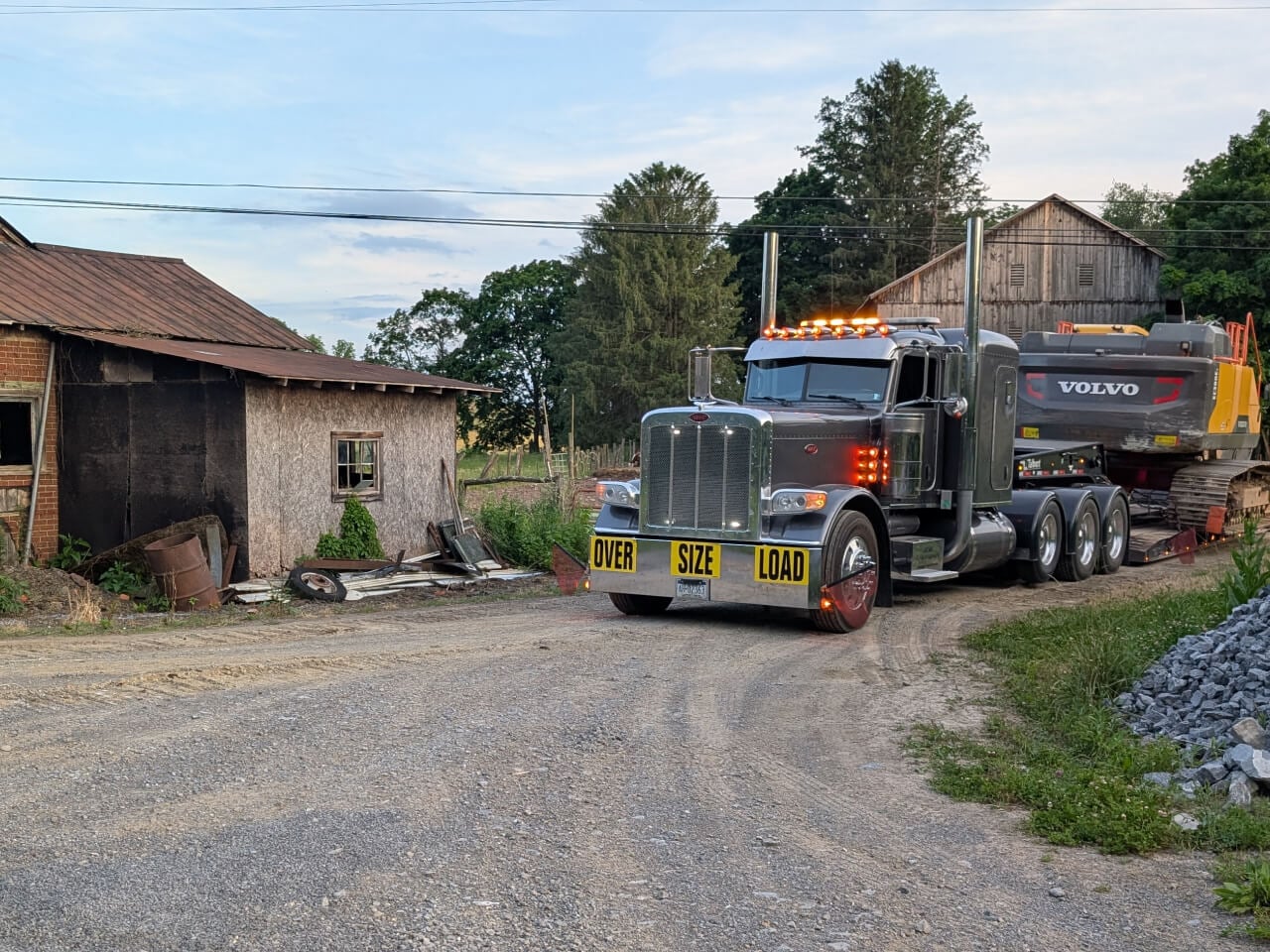 Oversize Load Truck Hauling by barn