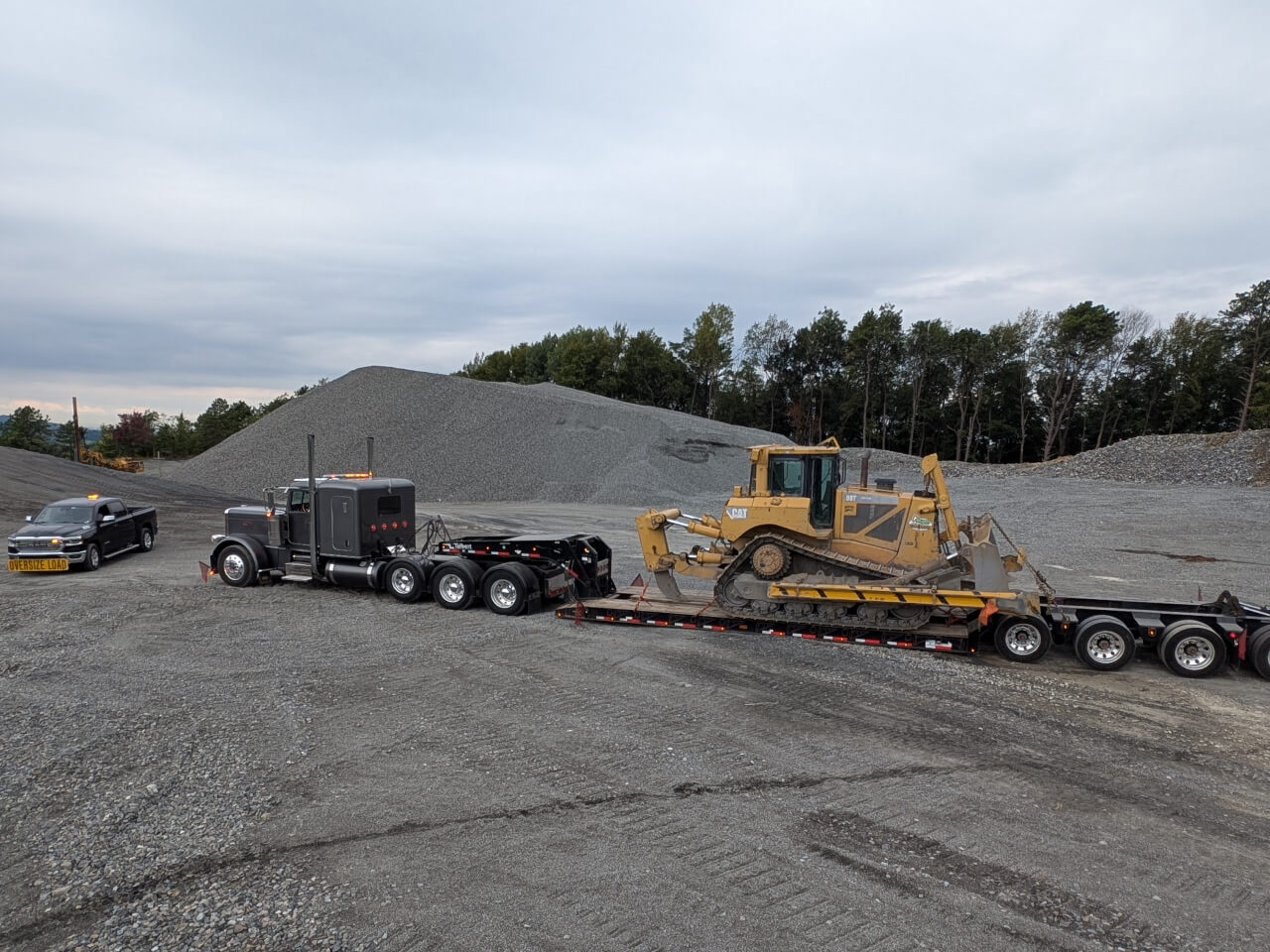 Truck Hauling Excavator
