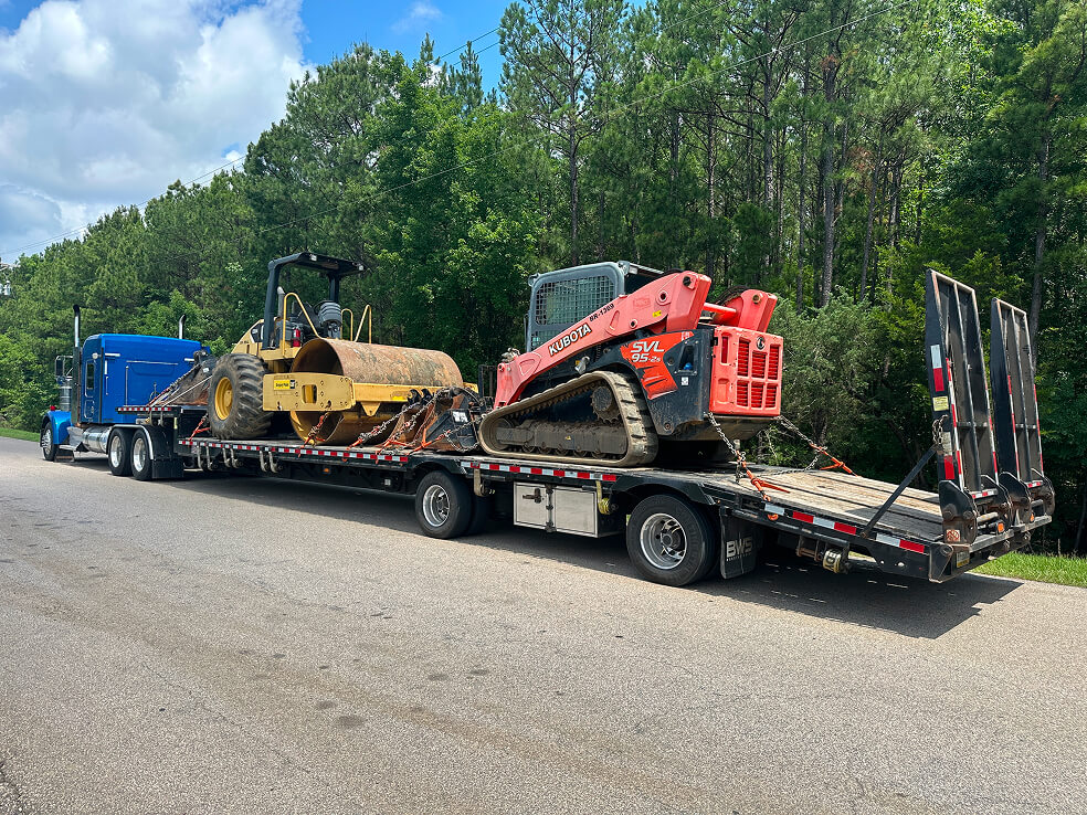 Truck Hauling multiple construction equipment